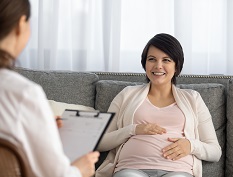 Pregnant woman talking with case manager