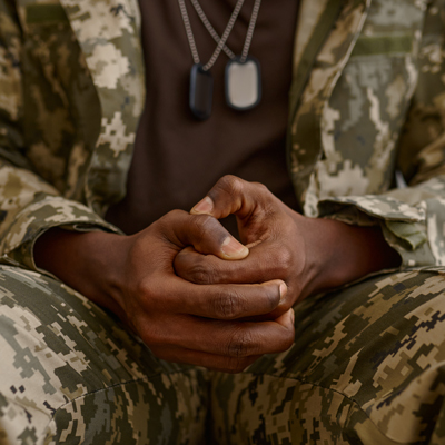 veteran sitting with hands clasped